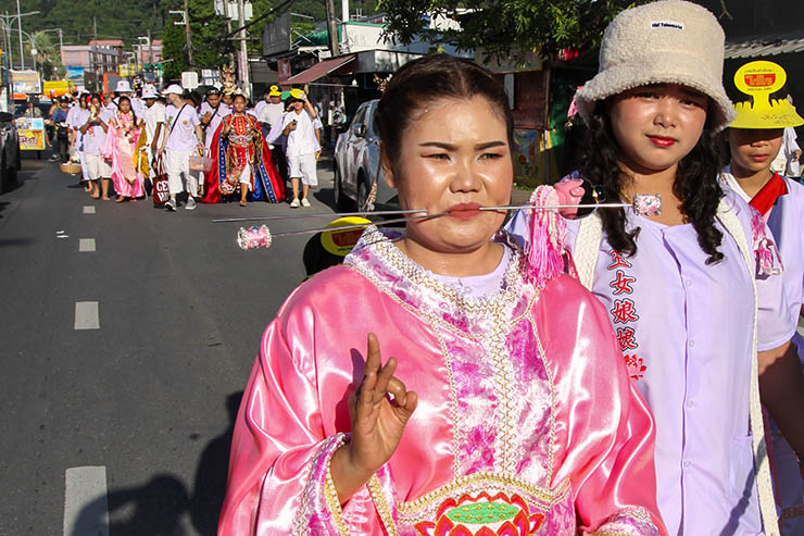 Pierced women walking in a street procession through Phuket during Jay or Vegetarian Festival, also known as Thailand's self-mutilation festival; photo by Ivan Kralj.