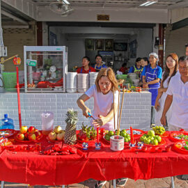 People at a makeshift altar set on the street of Phuket, waiting for the procession of ma song spirit medium to pass by and give their blessings during Jay or Phuket Vegetarian Festival; photo by Ivan Kralj.