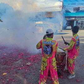 Drummers in the midst of a smoke created by exploding firecrackers in the streets of Phuket, during Jay or Phuket Vegetarian Festival; photo by Ivan Kralj.