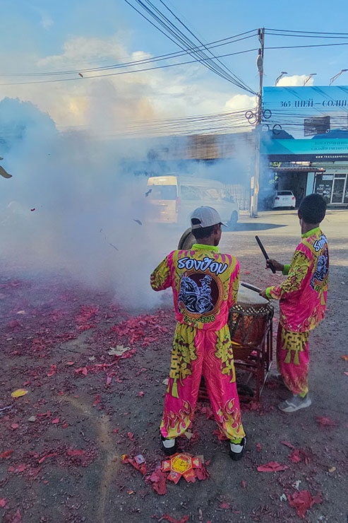 Drummers in the midst of a smoke created by exploding firecrackers in the streets of Phuket, during Jay or Phuket Vegetarian Festival; photo by Ivan Kralj.
