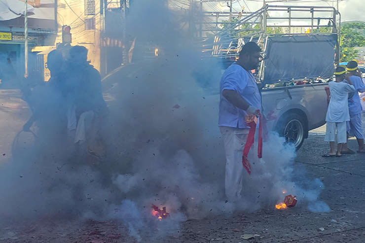 Firecrackers exploding and creating smoke in the streets of Phuket, during Jay or Phuket Vegetarian Festival; photo by Ivan Kralj.