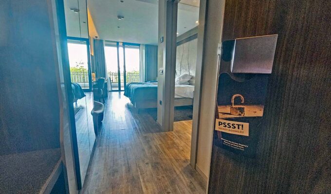 An open door to one of the guest rooms in Hotel Jama, Postojna, Slovenia, with a do-not-disturb sign promoting Secret Rooms, hotel's interactive experience where guests can visit communist-era spy center deep in the hotel's architecture; photo by Ivan Kralj.