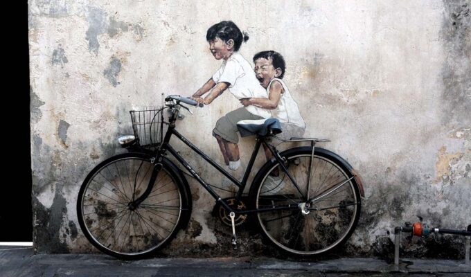 Little Children on a Bicycle mural by Ernest Zacharevic, a street art piece in George Town, Penang, Malaysia; photo by Jan Hecking.