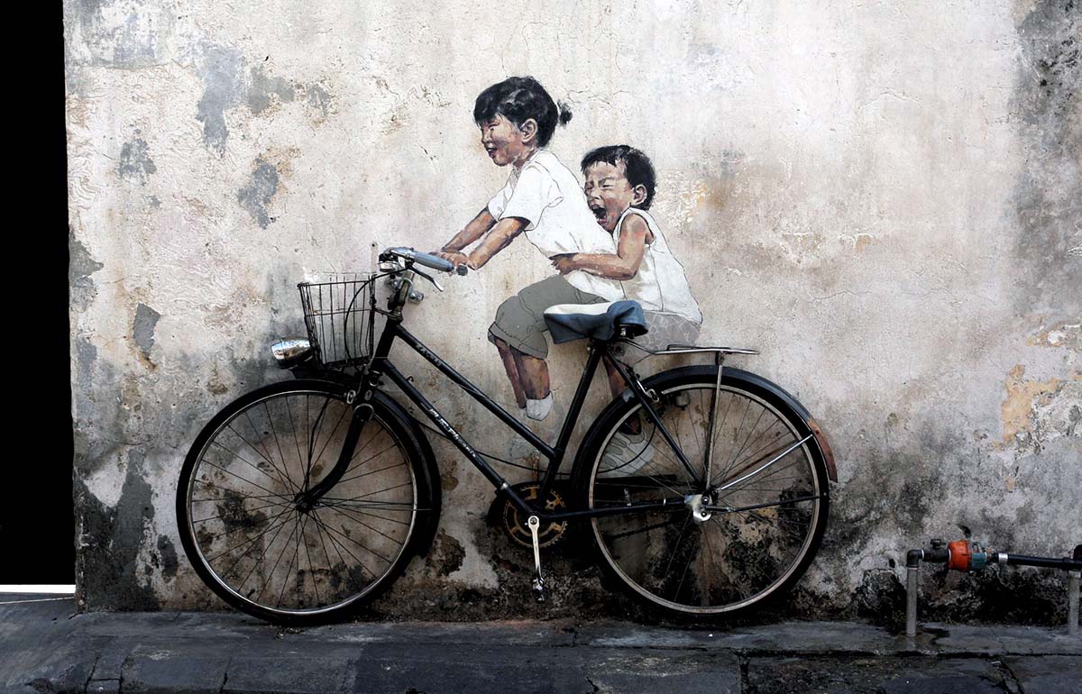 Little Children on a Bicycle mural by Ernest Zacharevic, a street art piece in George Town, Penang, Malaysia; photo by Jan Hecking.