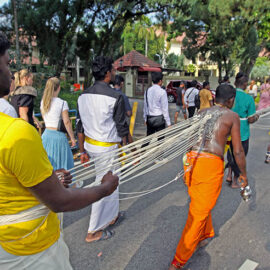 Hindu devotee pulling vette mulle kavadi (hooks with attached ropes in the skin of his back) in honor of Lord Murugan, during Thaipusam Festival in Penang, Malaysia; photo by Ivan Kralj.