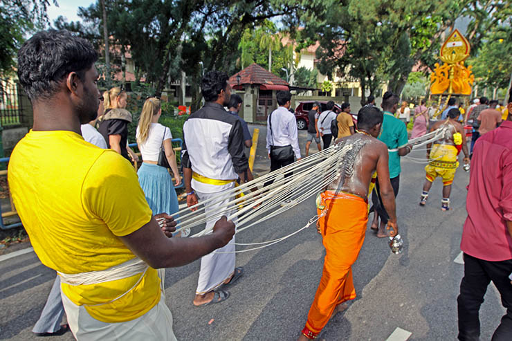 Hindu devotee pulling vette mulle kavadi (hooks with attached ropes in the skin of his back) in honor of Lord Murugan, during Thaipusam Festival in Penang, Malaysia; photo by Ivan Kralj.