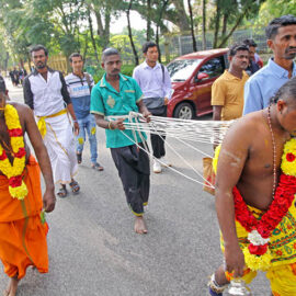 Two Hindu devotees with pierced foreheads, pulling vette mulle kavadi (hooks with attached ropes in the skin of their back) in honor of Lord Murugan, during Thaipusam Festival in Penang, Malaysia; photo by Ivan Kralj.