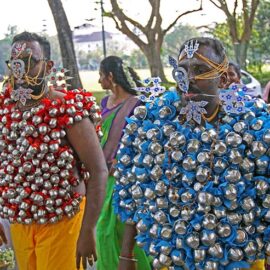 Hindu devotees carrying koodam mulle kavadi - milk pots pierced on their torsos, and their foreheads, cheeks and tongue pierced with little spears (alavu kavadi) in honor of Lord Murugan, during Thaipusam Festival in Penang, Malaysia; photo by Ivan Kralj.