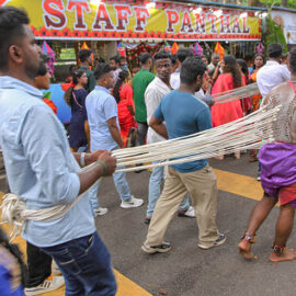 Two Hindu devotees pulling vette mulle kavadi (hooks with attached ropes in the skin of their back) in honor of Lord Murugan, during Thaipusam Festival in Penang, Malaysia; photo by Ivan Kralj.