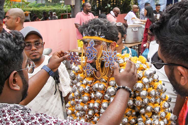 Hindu devotee carrying koodam mulle kavadi - milk pots pierced on his torso, and with forehead, cheeks and tongue pierced with little spears (alavu kavadi) in honor of Lord Murugan, during Thaipusam Festival in Penang, Malaysia; photo by Ivan Kralj.