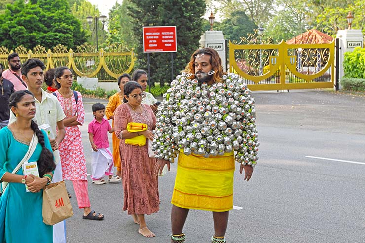 Hindu devotee carrying koodam mulle kavadi - milk pots pierced on his torso, and with cheeks pierced with little spears (alavu kavadi) in honor of Lord Murugan, during Thaipusam Festival in Penang, Malaysia; photo by Ivan Kralj.