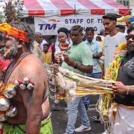 Hindu devotee pulling vette mulle kavadi (hooks with attached ropes in the skin of his back) while carrying koodam mulle kavadi - milk pots pierced on their torso - in honor of Lord Murugan, during Thaipusam Festival in Penang, Malaysia; photo by Ivan Kralj.