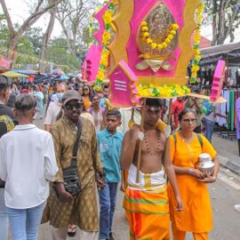 A young man carrying a mayil kavadi during Thaipusam in Penang, Malaysia; photo by Ivan Kralj.