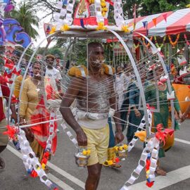 Hindu devotee carrying an alagu kavadi (a burden pierced for his torso) during Thaipusam in Penang, Malaysia; photo by Ivan Kralj.