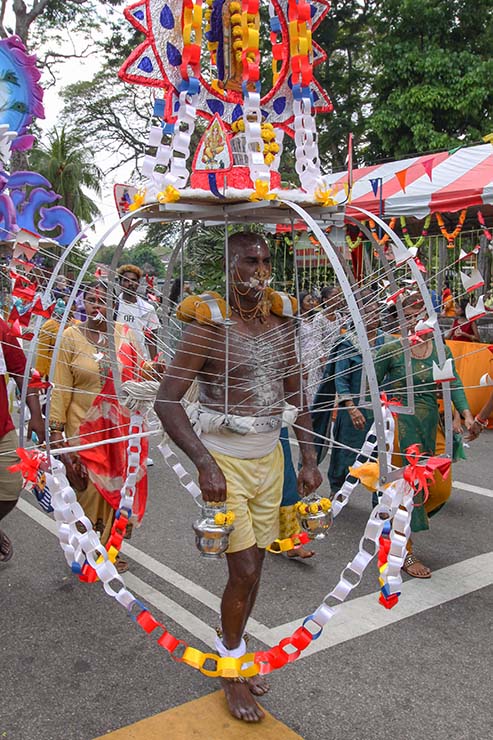 Hindu devotee carrying an alagu kavadi (a burden pierced for his torso) during Thaipusam in Penang, Malaysia; photo by Ivan Kralj.