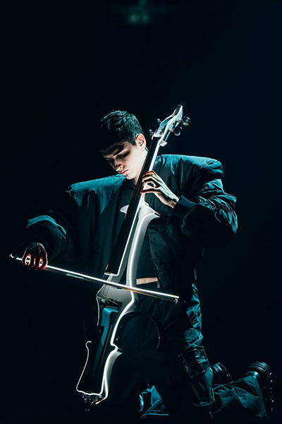 Abor, from Abor & Tynna, playing cello on Eurovision stage, where Austro-Hungarian siblings represent Germany; photo by Sarah Louise Bennett / EBU.