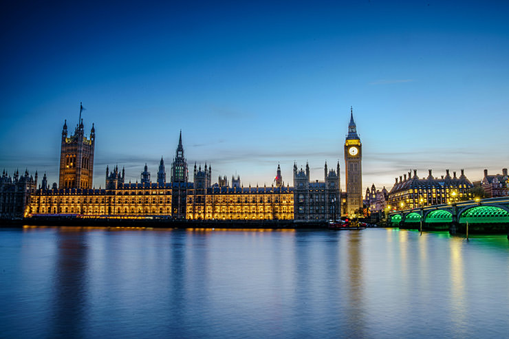Houses of Parliament and Big Ben at dusk, in London, UK; photo by Jesse Collins / Unsplash.