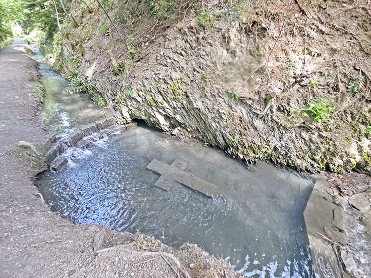 Underwater cross marked with a year 1430 when the Bisse du Torrent Neuf was constructed in Saviese, Switzerland; photo by Ivan Kralj.