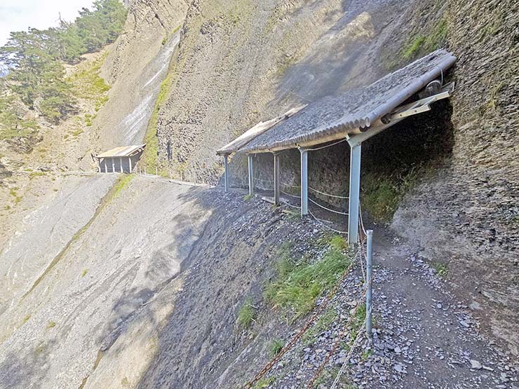 Covered shelters of Couvert du Marmouet, protecting from a rockfall at Bisse du Torrent Neuf hike in Saviese, Switzerland; photo by Ivan Kralj.
