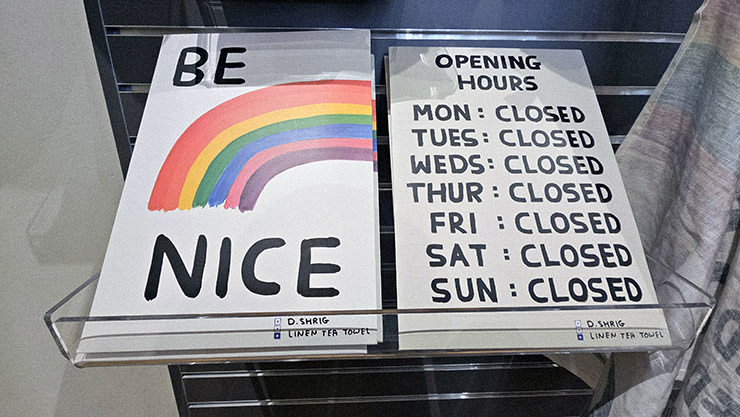David Shrigley's linen tea towels, one with "Be nice" message and a rainbow, and the other one with "Opening hours" (every day of the week marked as closed) - products available at the gift shop of Kunstmuseum Basel, Switzerland; photo by Ivan Kralj.