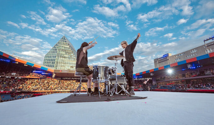 Baby Lasagna band, drummer and singer Marko Purišić, performing on the top of a cube stage at St. Jakob-Park stadium during the Arena Plus Eurovision pre-show; credit Kanton Basel-Stadt, photo by Mood Studios AG.