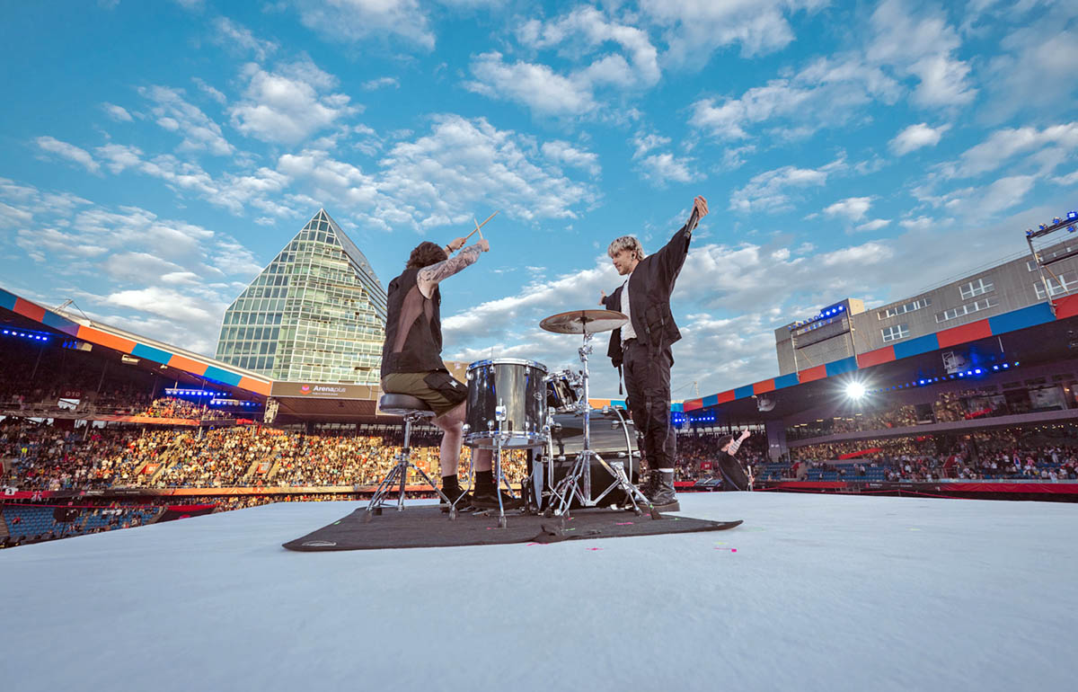 Baby Lasagna band, drummer and singer Marko Purišić, performing on the top of a cube stage at St. Jakob-Park stadium during the Arena Plus Eurovision pre-show; credit Kanton Basel-Stadt, photo by Mood Studios AG.