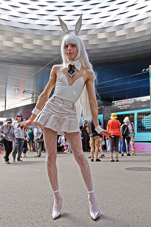 Cosplayer dressed as Blanc bunny girl from "Goddess of Victory: Nikke" sci-fi RPG shooter game, at Fantasy Basel, the Swiss Comic Con; photo by Ivan Kralj.