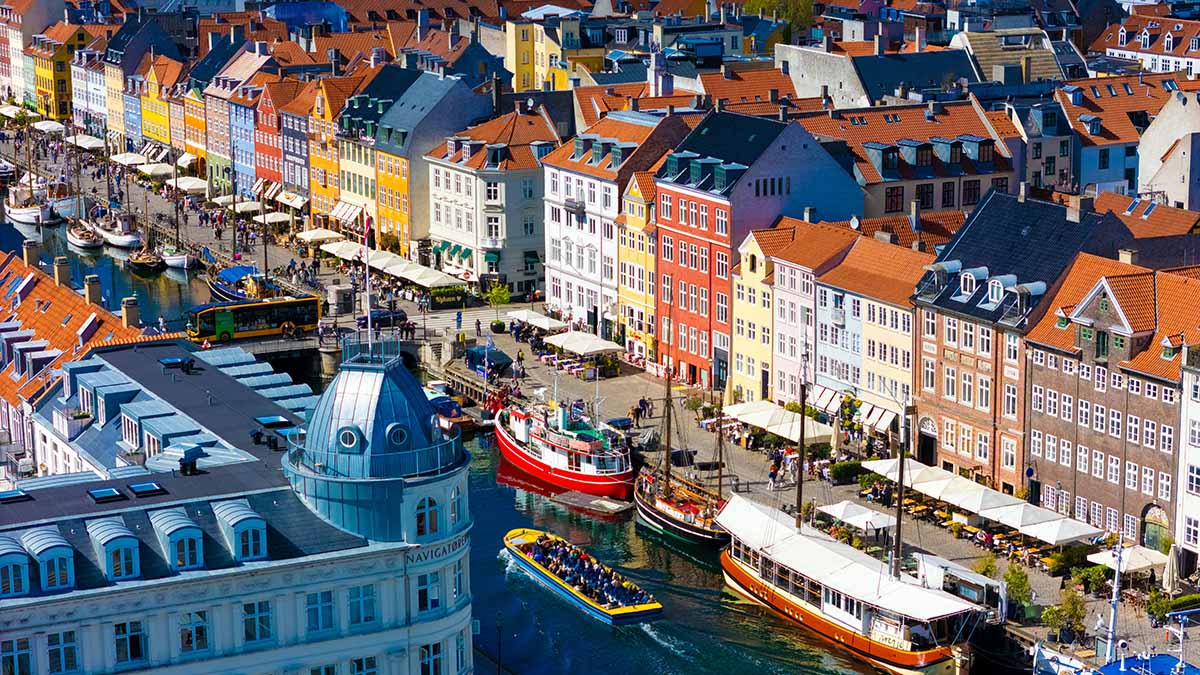 Colorful canal-side buildings in Copenhagen, Denmark; photo by Mylo Kaye / Unsplash.