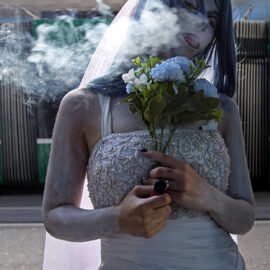 Cosplayer dressed as Tim Burton's Corpse Bride, puffing an e-cigarette smoke at Fantasy Basel, the Swiss Comic Con; photo by Ivan Kralj.