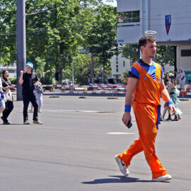 Cosplayer dressed as Goku from "Dragon Ball" manga series, walking across the Messeplatz at Fantasy Basel, the Swiss Comic Con; photo by Ivan Kralj.