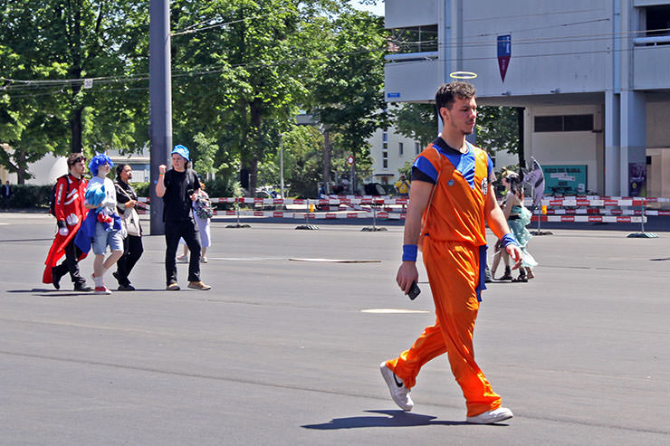 Cosplayer dressed as Goku from "Dragon Ball" manga series, walking across the Messeplatz at Fantasy Basel, the Swiss Comic Con; photo by Ivan Kralj.