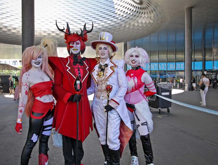 Cosplayers dressed up as Vaggie, Alastor, Lucifer Morningstar, and Angel Dust from "Hazbin Hotel", the American adult animated TV series, at Fantasy Basel, the Swiss Comic Con, held at Messe Basel; photo by Ivan Kralj.