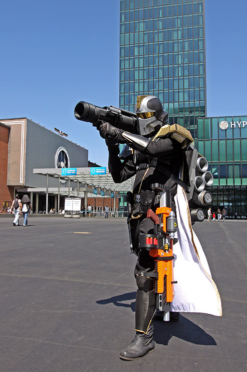 Cosplayer dressed as an elite warrior from "Helldivers" video game shooting from a rocket launcher at Fantasy Basel, the Swiss Comic Con; photo by Ivan Kralj.