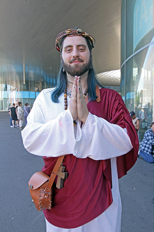 Cosplayer dressed as Jesus, praying at Fantasy Basel, the Swiss Comic Con; photo by Ivan Kralj.