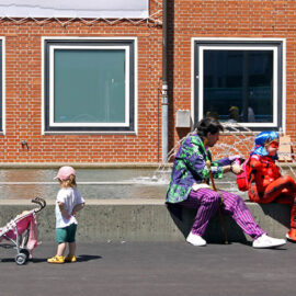 Cosplayer dad dressed as Joker with a daughter dressed as Ladybug, taking a break at Fantasy Basel, the Swiss Comic Con; photo by Ivan Kralj.