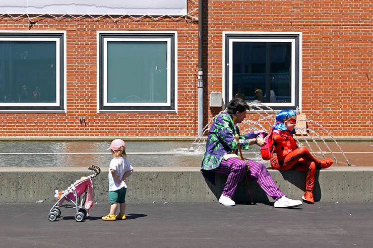 Cosplayer dad dressed as Joker with a daughter dressed as Ladybug, taking a break at Fantasy Basel, the Swiss Comic Con; photo by Ivan Kralj.