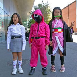 Mongolian children cosplaying as the Pink Guard from "Squid Game" TV show, and Nezuko Kamado from "Dragon Slayer" manga series, at Fantasy Basel, the Swiss Comic Con; photo by Ivan Kralj.