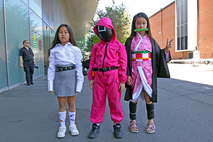Mongolian children cosplaying as the Pink Guard from "Squid Game" TV show, and Nezuko Kamado from "Dragon Slayer" manga series, at Fantasy Basel, the Swiss Comic Con; photo by Ivan Kralj.