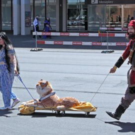 Cosplayers dressed as Princess Jasmine from Disney's film "Aladdin" and a medieval soldier pulling a cart with stuffed tiger Rajah across the Messeplatz at Fantasy Basel, the Swiss Comic Con; photo by Ivan Kralj.