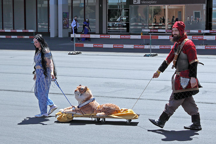 Cosplayers dressed as Princess Jasmine from Disney's film "Aladdin" and a medieval soldier pulling a cart with stuffed tiger Rajah across the Messeplatz at Fantasy Basel, the Swiss Comic Con; photo by Ivan Kralj.