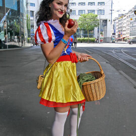 Cosplayer dressed as Snow White, holding a red apple, at Fantasy Basel, the Swiss Comic Con; photo by Ivan Kralj.