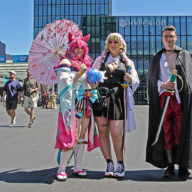 Cosplayers dressed as Spirit Blossom Ahri from "League of Legends" multiplayer online battle arena, Mitsuri Kanroji from "Demon Slayer" manga series, and Shanks from "One Piece" manga series, at Fantasy Basel, the Swiss Comic Con; photo by Ivan Kralj.