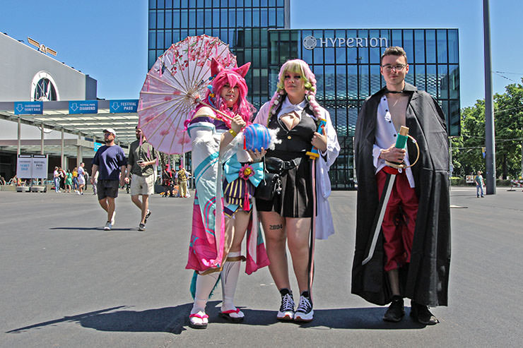 Cosplayers dressed as Spirit Blossom Ahri from "League of Legends" multiplayer online battle arena, Mitsuri Kanroji from "Demon Slayer" manga series, and Shanks from "One Piece" manga series, at Fantasy Basel, the Swiss Comic Con; photo by Ivan Kralj.