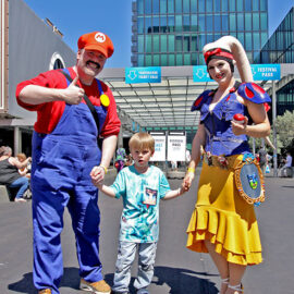A boy with cosplayer parents dressed as Super Mario and Twi’lek Snow White, at Fantasy Basel, the Swiss Comic Con; photo by Ivan Kralj.