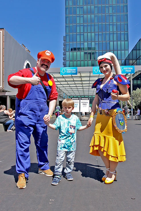A boy with cosplayer parents dressed as Super Mario and Twi’lek Snow White, at Fantasy Basel, the Swiss Comic Con; photo by Ivan Kralj.