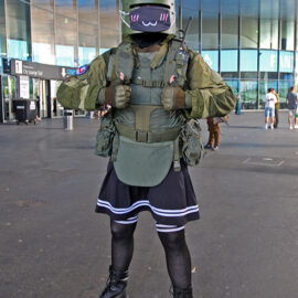 Cosplayer with a top part dressed as Tachanka from "Tom Clancy's Rainbow Six Siege" video game, and in the bottom part, wearing a skirt, at Fantasy Basel, the Swiss Comic Con; photo by Ivan Kralj.