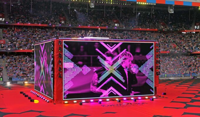 A giant screen-cube displaying Croatian musician Baby Lasagna performing at St. Jakob-Park stadium in Basel, Switzerland, during the Arena Plus Eurovision pre-show; photo by Ivan Kralj.