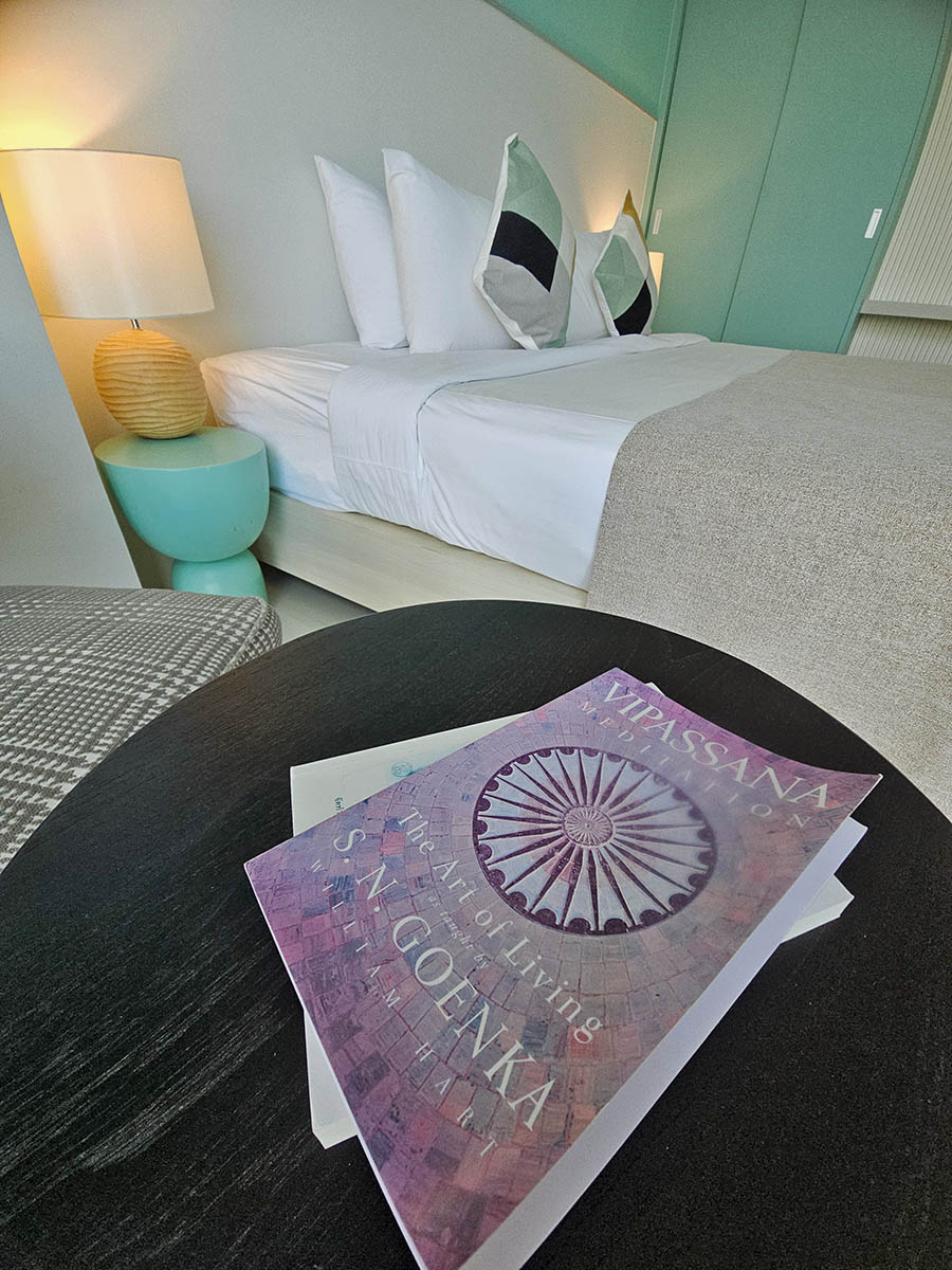 Vipassana Meditation book displayed next to the bed in a room at Hilltop Wellness Resort in Phuket, Thailand; photo by Ivan Kralj.