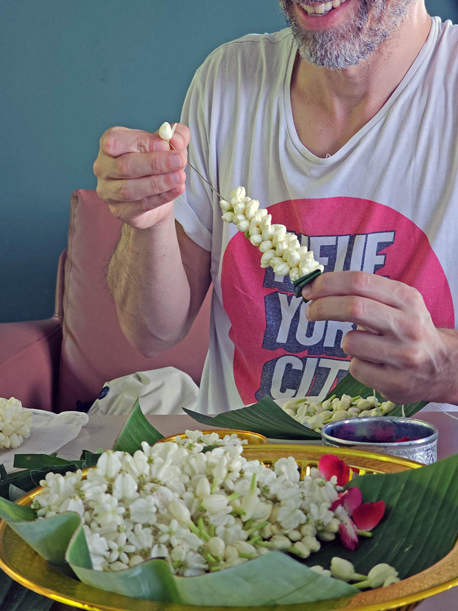 Travel blogger Ivan Kralj participating in a flower garland workshop at Hilltop Wellness Resort in Phuket, Thailand; photo by Ivan Kralj.