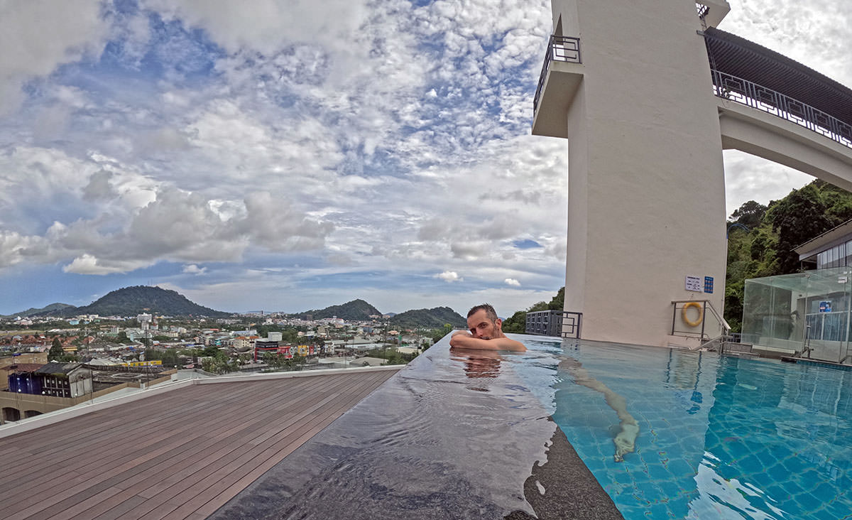 Travel journalist Ivan Kralj leaning on the edge of the infinity pool at the Hilltop Wellness Resort in Phuket, Thailand; photo by Ivan Kralj.